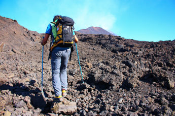 Meltingsisters - Trekking Mount Etna craters - a hill walker trekking the volcano