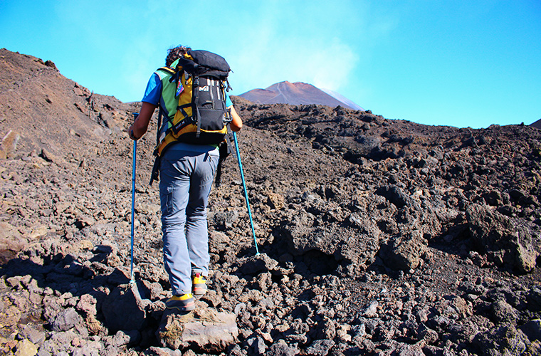 Meltingsisters - Trekking Mount Etna craters - a hill walker trekking the volcano