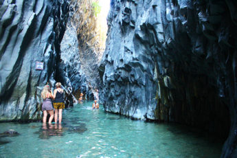 Meltingsisters - epic canyon Gole Alcantara with two woman standing in the water