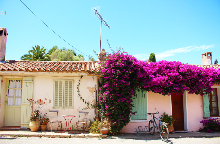 Picture-perfect Porquerolles island: view of the front of two houses again a bright blue sky