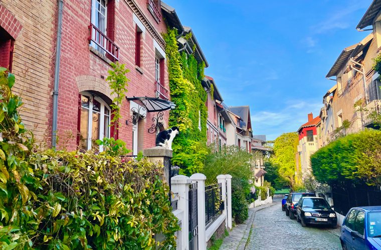 Quaint square montsouris - Standing in the middle of the road looking down at the colourful street