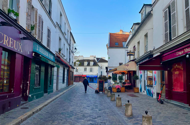 Snippets of a lockdown wonderland - A woman walking her dog as day breaks and a clear sky illuminates Montmartre