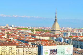 The 19th century Mole Antonelliana towering above the city with the mountain range of the alps in the background