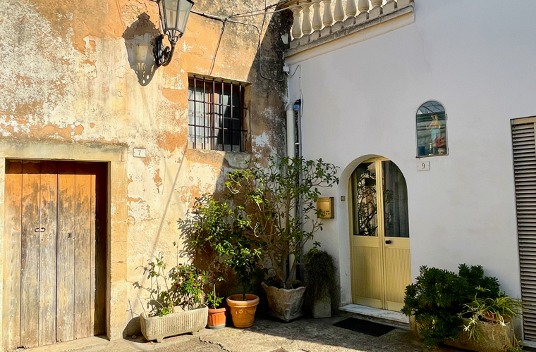 Golden hour light illuminating the facade of an inner courtyard